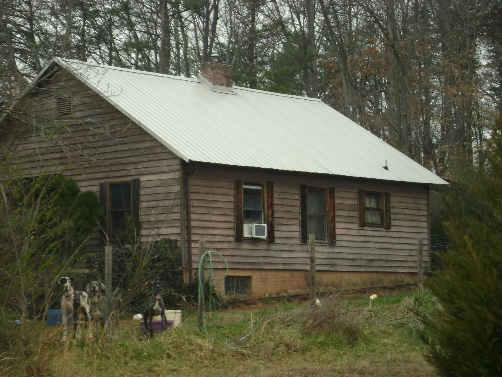 White metal roof on an old wood sided farmhouse, from a Asphalt Shingle Roof Repair job in New Milford